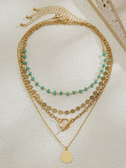 Layered Gold-Chain Necklace With Turquoise Beads And Circular Pendant